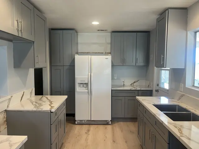 Grey shaker kitchen with white quartz counters veined in gold
