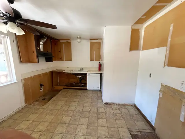 A kitchen on demo day: the old cabinets and counters stripped out, ready for the remodel